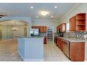 Bright kitchen with stainless steel appliances, tile backsplash, light countertops, and open floorplan at 4702 Corsage Dr, Lutz, FL 33558
