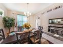 Beautiful dining area with large windows, designer curtains, and a decorative centerpiece at 4923 Eagle Rock Dr, Wimauma, FL 33598