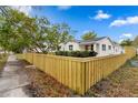 Charming single-story home with a well-maintained lawn and a newly constructed wooden fence at 4934 Dr Martin Luther King Jr N St, St Petersburg, FL 33703