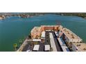 This aerial view shows the condo building complex with ample parking and bay views at 7665 Sun Island S Dr # 401, South Pasadena, FL 33707