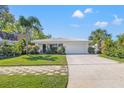 Lovely single-story home with a white exterior, a 2-car garage and beautiful front yard landscaping at 774 29Th N Ave, St Petersburg, FL 33704