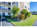 Corner condo building featuring well-manicured lawn and landscaping, providing a tranquil setting at 7975 58Th N Ave # 111, St Petersburg, FL 33709