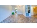Bright living room featuring modern flooring, chandelier lighting, and seamless transitions to the dining area at 7975 58Th N Ave # 111, St Petersburg, FL 33709