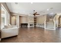 Spacious living room shows the fireplace, tiled floor, staircase and neutral color palette at 824 Islebay Dr, Apollo Beach, FL 33572
