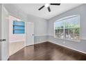 Cozy bedroom with hardwood floors, chair rail, and large window allowing ample natural light at 8714 Sandy Plains Dr, Riverview, FL 33578