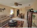 Open concept: living room flows into dining area with tile floors, ceiling fan, and large windows at 10039 62Nd N Ave # 14, St Petersburg, FL 33708
