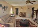 Cozy living room/dining area features tile floors, leather sofas, and a ceiling fan at 10039 62Nd N Ave # 14, St Petersburg, FL 33708