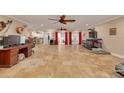 Spacious open-concept living area with tile flooring and bright natural lighting at 11434 Minnieola Dr, New Port Richey, FL 34654