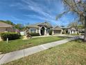 Beautifully landscaped front yard leading to a cozy home with a welcoming entrance at 1227 Big Creek Dr, Wesley Chapel, FL 33544