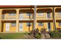 Exterior view of the property with yellow facade and well-maintained landscaping at 1301 S Hercules Ave # 3, Clearwater, FL 33764