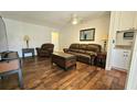Living room showcases hardwood floors, ceiling fan, and updated furniture at 1301 S Hercules Ave # 3, Clearwater, FL 33764