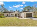 Attractive one-story house with a well-kept lawn, tasteful landscaping, and a two-car garage at 13376 Sooty Tern Ave, Brooksville, FL 34614