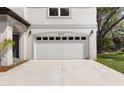 Attached two-car garage with white door on a modern-style home at 16417 Lake Byrd Dr, Tampa, FL 33618