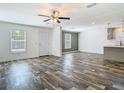 Inviting living room with a view to the front door, updated flooring and fresh neutral paint at 18079 Carrolwood Dr, Brooksville, FL 34604