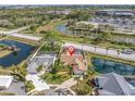 Stunning aerial view of a well-maintained home with a private pool and lush landscaping at 1996 Promenade Way, Clearwater, FL 33760