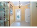Welcoming entryway featuring a chandelier and a door with decorative glass at 221 Shell Falls Dr, Apollo Beach, FL 33572