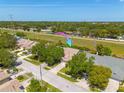 An aerial view of a single-Gathering home in a residential neighborhood with green space nearby at 3005 Brookfield Ln, Clearwater, FL 33761