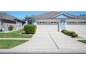 Exterior view of a well-maintained driveway leading to a two-car garage at 31815 Blythewood Way, Wesley Chapel, FL 33543