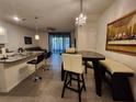Open-concept living area featuring a dining table, bar seating and access to outdoor space at 3267 Pleasant Willow Ct, Brandon, FL 33511