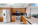 Modern kitchen featuring stainless steel appliances and stone countertops at 3639 Darston St, Palm Harbor, FL 34685