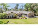Charming single-story home featuring a well-maintained lawn and beautiful landscaping at 401 Apache Trl, Brandon, FL 33511