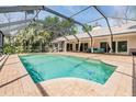 Inviting pool area featuring a screened enclosure and ample space for lounging and recreation at 401 Apache Trl, Brandon, FL 33511