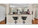 Bright kitchen with white cabinets, stainless steel appliances, and a breakfast bar at 427 5Th Nw St, Largo, FL 33770