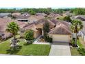 Aerial view of a charming single-story home with lush landscaping and a two-car garage at 4426 Brandon Ridge Dr, Valrico, FL 33594