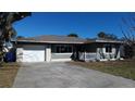 Inviting single-story home featuring a well-maintained lawn, attached garage and ample parking at 447 80Th Ave, St Pete Beach, FL 33706