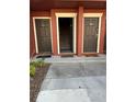 Townhouse building entrance featuring neatly numbered doors and welcome mats, exuding suburban charm at 5553 Baywater Dr, Tampa, FL 33615