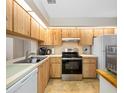 Efficient kitchen with stainless steel appliances, light wood cabinets, and ample counter space at 6357 Bahia Del Mar Blvd # 206, St Petersburg, FL 33715