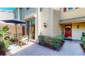 Cozy patio area with a table and chairs, perfect for outdoor dining and relaxation with access to the home's entry at 64 Pelican Pl, Belleair, FL 33756