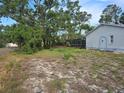 A side view of a house showing the screen porch and lawn at 6473 Blackbird Ave, Weeki Wachee, FL 34613