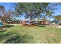 Well-maintained lawn and mature trees complement this brick home with a spacious front yard at 6804 Sea Gull S Dr, St Petersburg, FL 33707