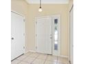 Bright foyer featuring neutral tile flooring and a front door with sidelight at 7233 Lumber Port Dr, Ruskin, FL 33573