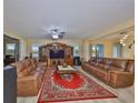 Open concept living room with tile flooring, ceiling fan, and lots of natural light at 10708 Planer Picket Dr, Riverview, FL 33569