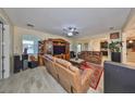 Spacious living room featuring tile floors, a ceiling fan and comfortable leather furniture at 10708 Planer Picket Dr, Riverview, FL 33569