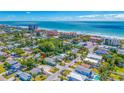Beautiful aerial view of a residential neighborhood near the ocean with lush greenery and clear blue skies at 119 13Th Ave, Indian Rocks Beach, FL 33785