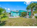 Bright and inviting single-story home featuring a well-maintained lawn and mature palm trees at 119 13Th Ave, Indian Rocks Beach, FL 33785