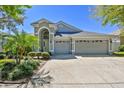 Charming single-Gathering home with a three-car garage and a well-manicured lawn at 1210 Paradise Lake Dr, Tarpon Springs, FL 34689