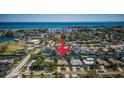 An aerial view of a waterfront home surrounded by canals, offering picturesque scenery and convenient access to boating activities at 1233 Eden Isle Ne Dr, St Petersburg, FL 33704