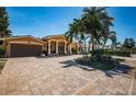 Elegant single-Gathering home featuring a charming facade, meticulously maintained lawn, and a spacious driveway at 1233 Eden Isle Ne Dr, St Petersburg, FL 33704