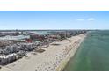 Picturesque coastal view of beachside condo with beachgoers, white sand, and ocean at 15 Avalon St # 601, Clearwater Beach, FL 33767
