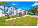 Inviting two-story home with a green lawn and a paved driveway leading to the garage at 1741 Nevada Ne Ave, St Petersburg, FL 33703