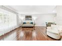 Sun-filled living area with hardwood floors, showcasing an open layout and comfortable seating at 2124 Crowsnest Dr, Palm Harbor, FL 34685
