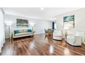Bright living room boasting hardwood floors, neutral paint, and elegant furnishings at 2124 Crowsnest Dr, Palm Harbor, FL 34685