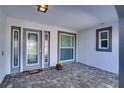 Welcoming front porch with gray trim around the leaded glass front door and the window panes at 218 Leeward Is, Clearwater Beach, FL 33767