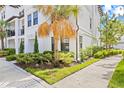 Elegant multi-story condo building with lush landscaping and a well-maintained lawn at 5120 Bridge St # 6, Tampa, FL 33611
