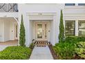 Charming condo front entrance with decorative plants and a welcoming door mat at address 5120 at 5120 Bridge St # 6, Tampa, FL 33611