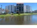 Condo building with private balconies, lake views and lush, mature landscaping at 5700 Escondida S Blvd # 506, St Petersburg, FL 33715